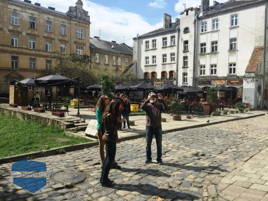 family standing in front of monument, man taking a picture